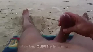 Curved cock wank and cum at unclad beach
